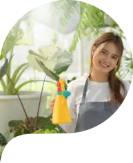 Young woman caring for trees in a greenhouse, planting trees, plant care equipment.